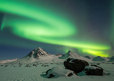 Aurora Borealis over Snowy Mountains
