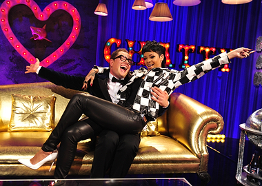 Rihanna and Alan Carr on a Gold Couch