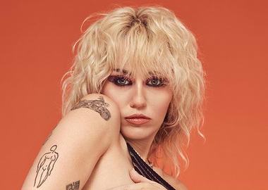 Miley Cyrus with Blonde Hair and Tattoos