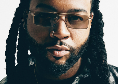 Close-up of a partynextdoor with dreadlocks and sunglasses