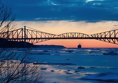 Bridge over icy water at sunset