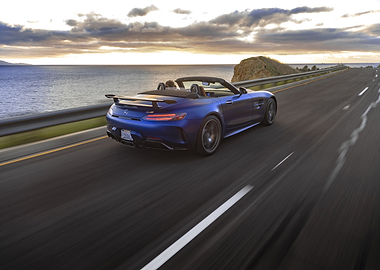 Blue convertible sports car on coastal road