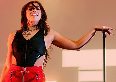 tate mcrae in black bodysuit and red skirt