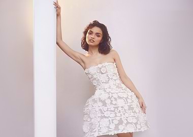 rachel zegler in a white floral dress