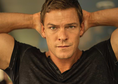 alan ritchson as reacher with hands behind head