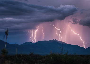 Lightning strikes over mountains