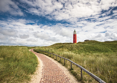Red lighthouse on a grassy dune