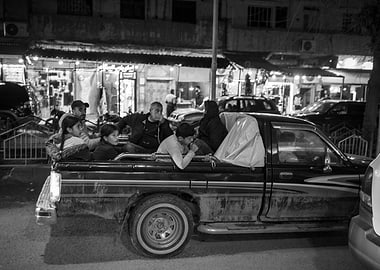Family rides in the back of a pickup truck in Syria (Rojava)