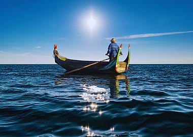 Fisherman rowing boat at sea