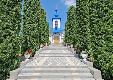 Church Entrance with Cypress Trees and Flowers