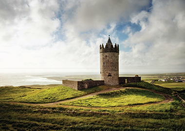 Castle on a grassy hill overlooking the sea
