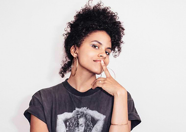 zazie beetz with Curly Hair and Hoop Earrings