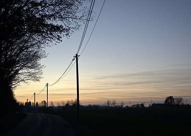 Rural Road at Dusk with Power Lines
