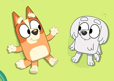 Bluey and Bingo lying on grass