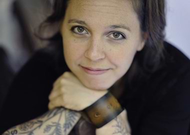 erin mckeown with tattoos and leather cuff