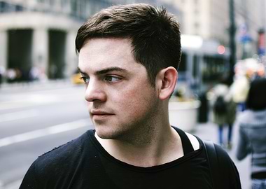 nico muhly looking away in a city