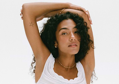 olivia dean with Star Tattoo and Curly Hair