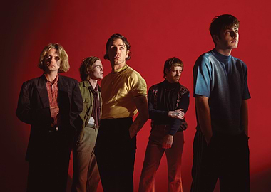 Band Posing Against Red Background fontaines dc