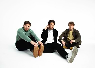 Three men posing on a white background