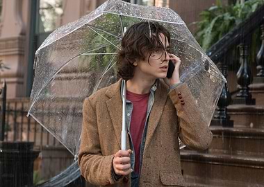 Young man with umbrella on phone