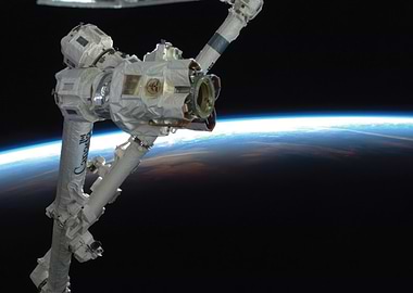 Robotic Arm in Orbit Above Earth