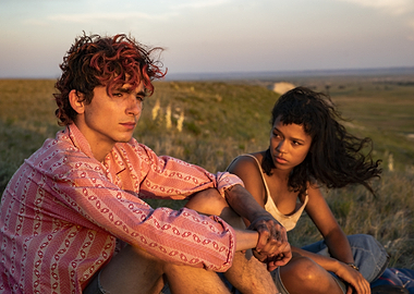 Couple sitting on a grassy hill