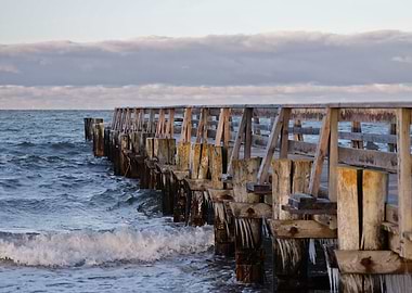 Wooden pier over choppy ocean waves