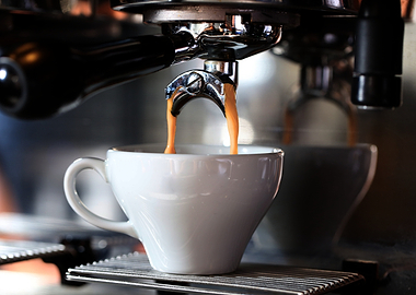 Espresso pouring into a white cup