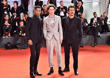 Three men on a red carpet