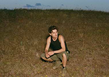 Man crouching in a field