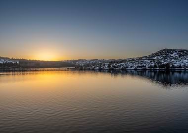 Sunrise over a snow-dusted lake