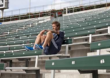 David Beckham sitting on stadium bleachers