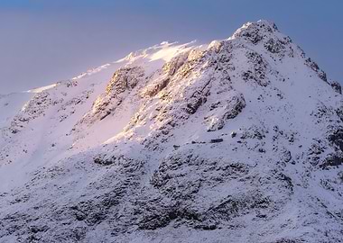 Snow-covered mountain peak at sunrise Glencoe