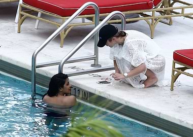 Two women by a swimming pool