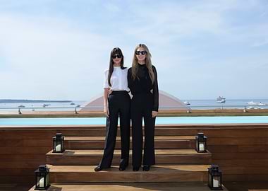 Two women posing by a pool
