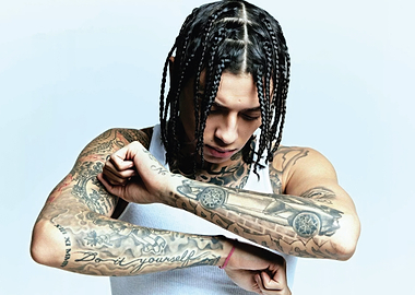 central cee with extensive tattoos and braided hair