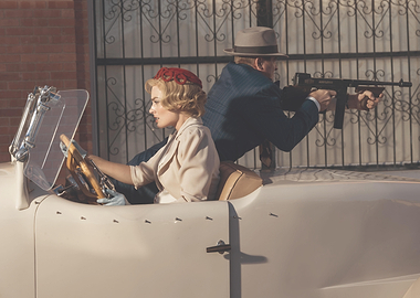Couple in a vintage car with a tommy gun