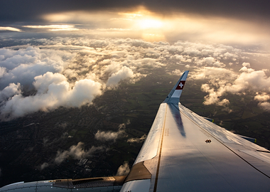Airbus A321Neo Swiss Airlines wing over clouds at sunset