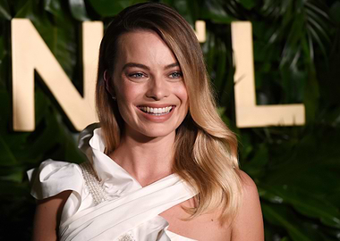 Margot Robbie smiling at event