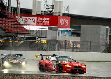 Race cars on a wet Barcelona track