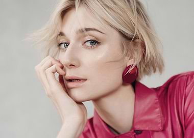 Elizabeth Debicki with blonde hair and pink shirt