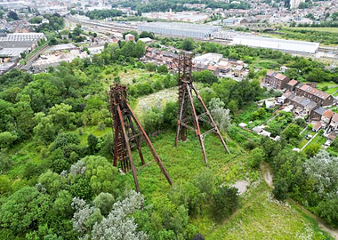 Abandoned mining towers in overgrown landscape