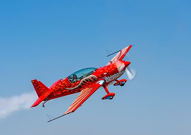 Dragon-themed aerobatic plane in flight