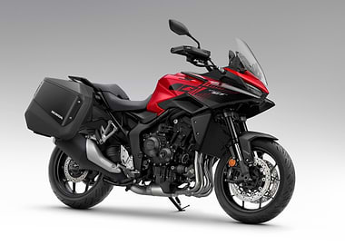 Red Honda motorcycle with saddlebags