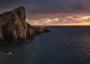 Lighthouse on a cliff at sunset
