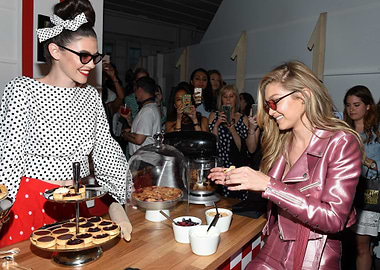 Gigi Hadid and model at a dessert bar