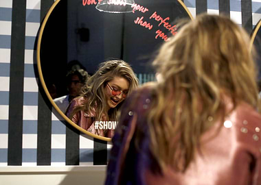 Model in Pink Jacket Posing in Mirror