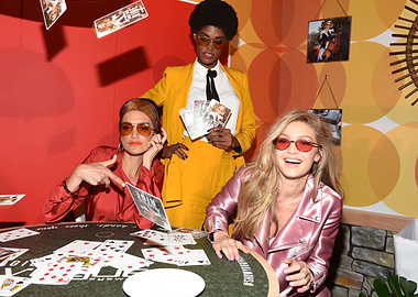 Celebrities playing cards with sunglasses