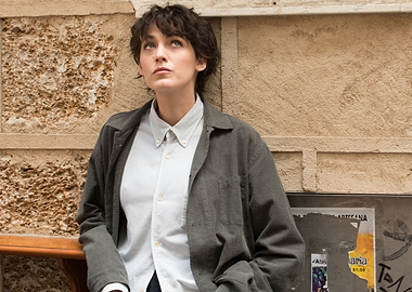 Woman in casual outfit leaning against wall