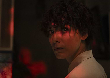 Woman with red light on face